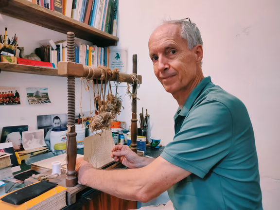 Michel working at his book sewing machine