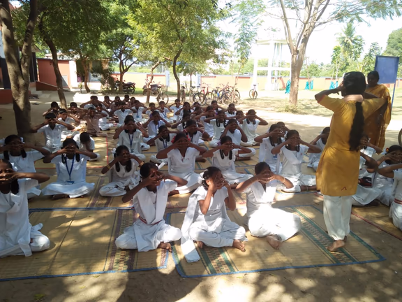 Yoga and health education: Muthukumari taking a class in Nesal school