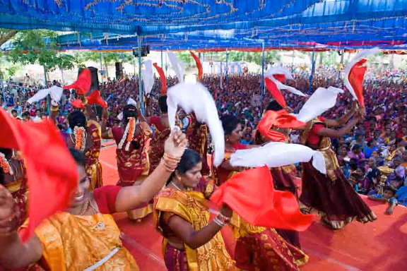 Women from AVAG's Women's Self-Help Groups perform in front of an audience of 5000 women