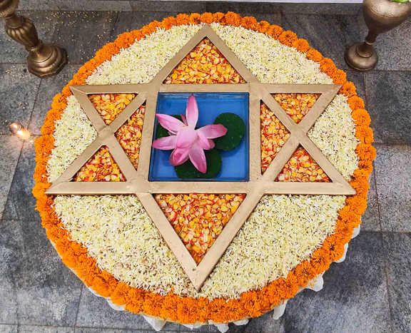 Flower arrangement with Sri Aurobindo’s symbol