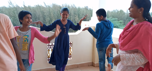 Isai Amabalam students acting out the story of the thirsty crow and the low level of water in a pot. Top: the water level came up
