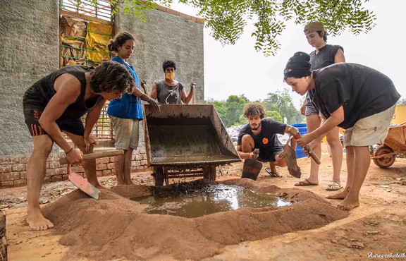 Volunteers and young Aurovilians work together at the Joy of Impermanence project