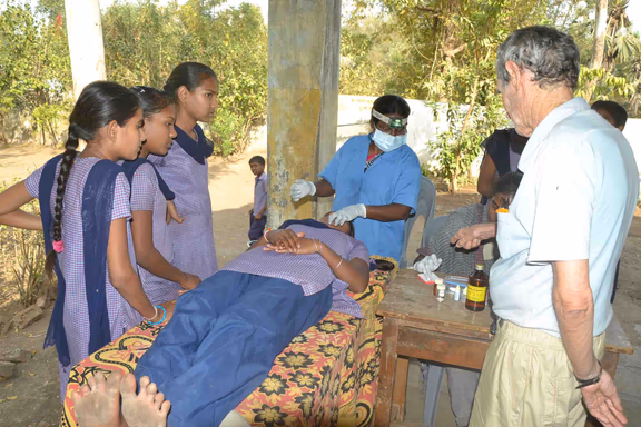 Jacques (right) overseeing the training of village youth