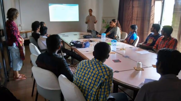 Lyle gives a presentation on the Auroville Economy in the Town Hall meeting room