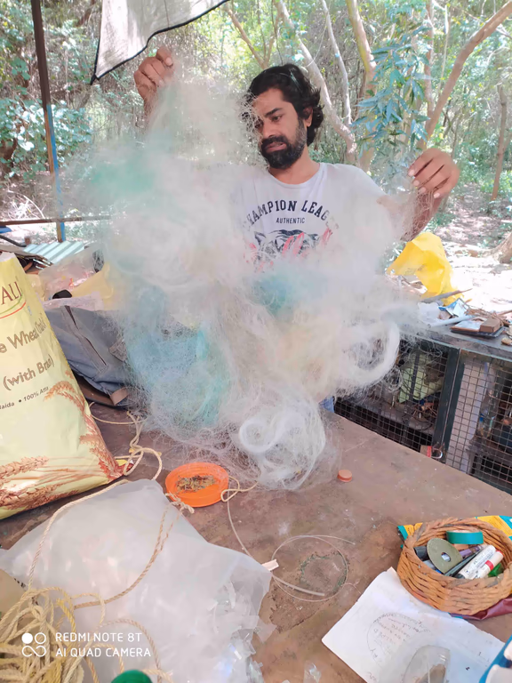 Satya working with a fishing net